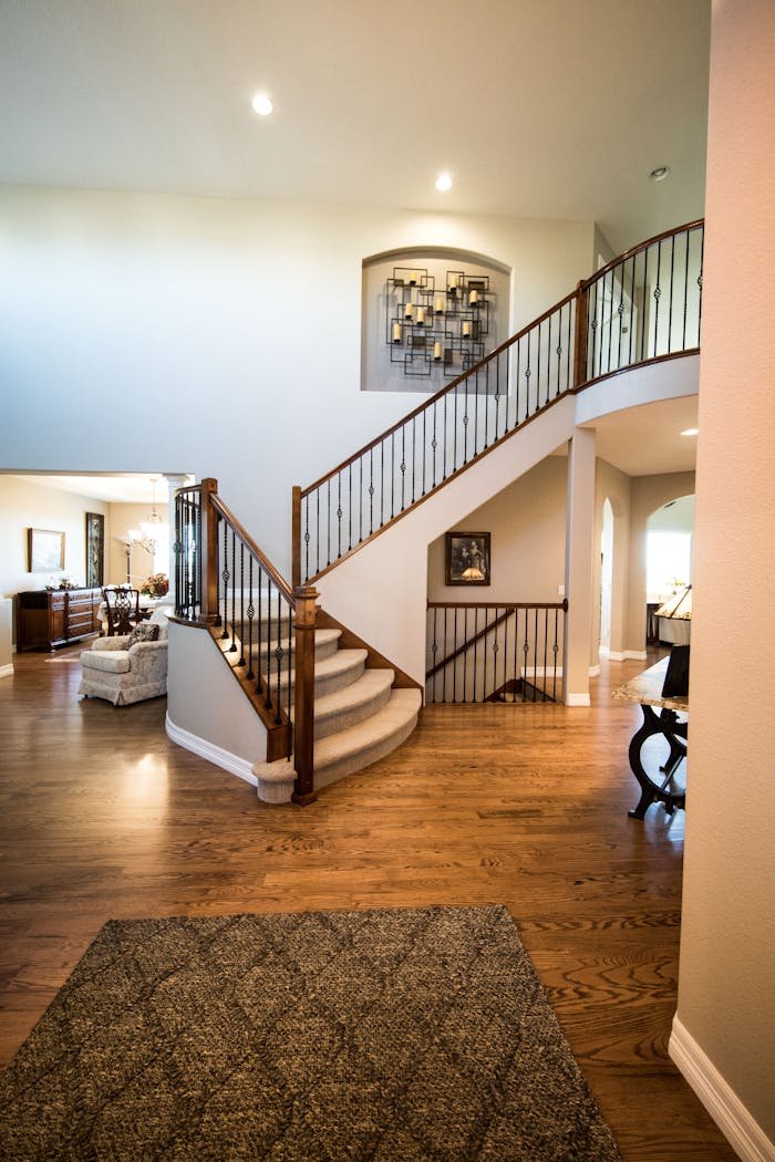 Mastering the First Impression: Your intriguing post title goes here Spacious modern interior showcasing a stylish wooden staircase and elegant decor.